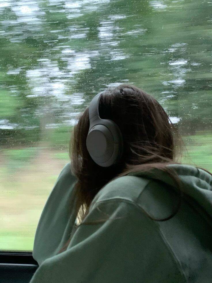 Sad pfp Profile Picture of Woman with Headphones Looking Out the Window