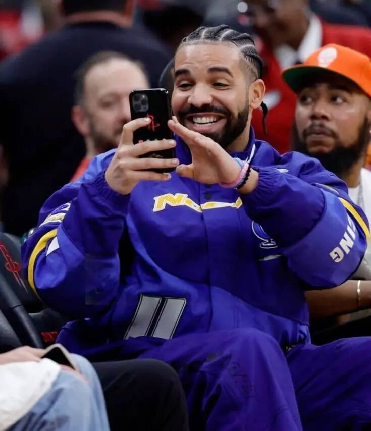 Drake pfp Profile Picture Smiling with Phone at Basketball Game